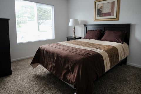 Premium unit master bedroom, mature trees outside window, natural lighting, in Regency apartments Bettendorf, Iowa